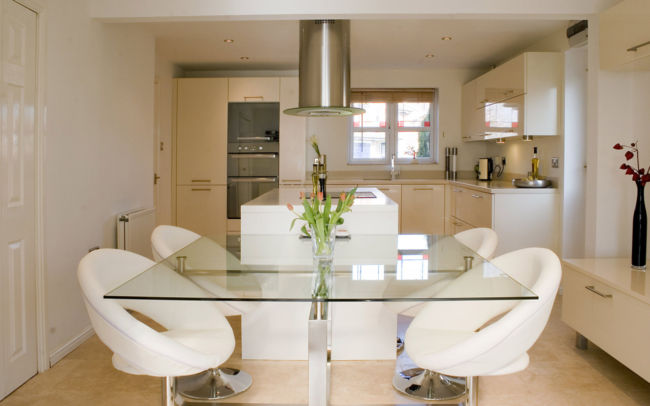 luxury-glass-top-dining-table-with-flower-centrepiece-feat-modern-white-kitchen-chairs-plus-round-exhaust-hood