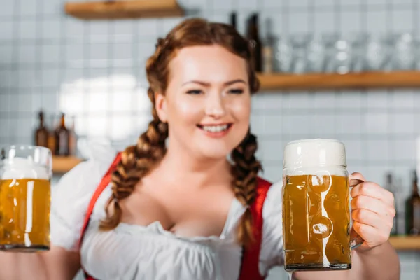 Selective Focus Oktoberfest Waitress Traditional Bavarian Dress Showing Mugs Light — стоковое фото