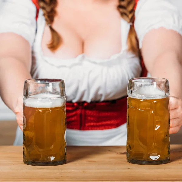 Partial View Oktoberfest Waitress Traditional Bavarian Dress Putting Mugs Light — стоковое фото