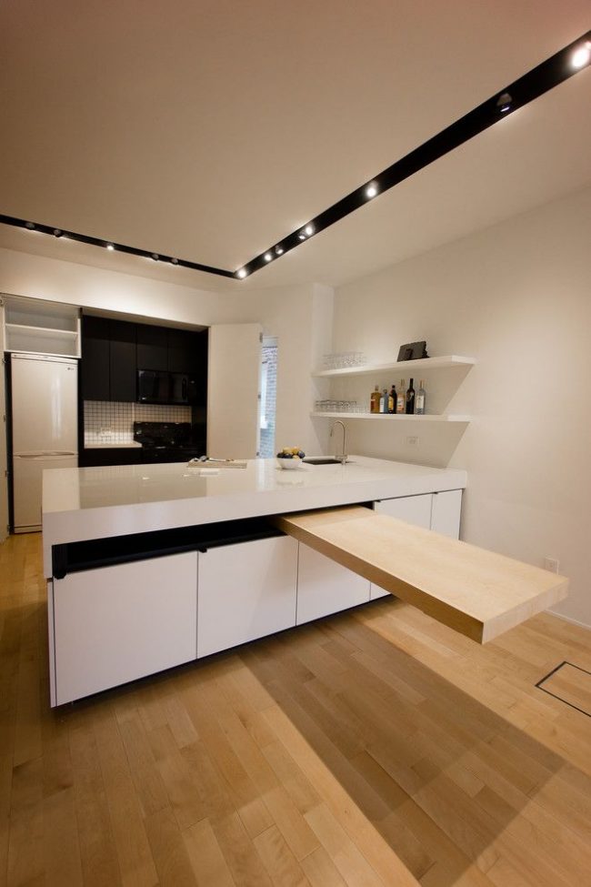 Выдвижной стол из кухонного острова на кухне в стиле минимализм