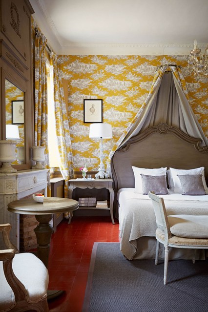 Желтая стена с узорами в спальне