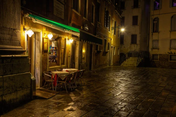 Небольшое уличное кафе в Венеции, Италия, ночью — стоковое фото